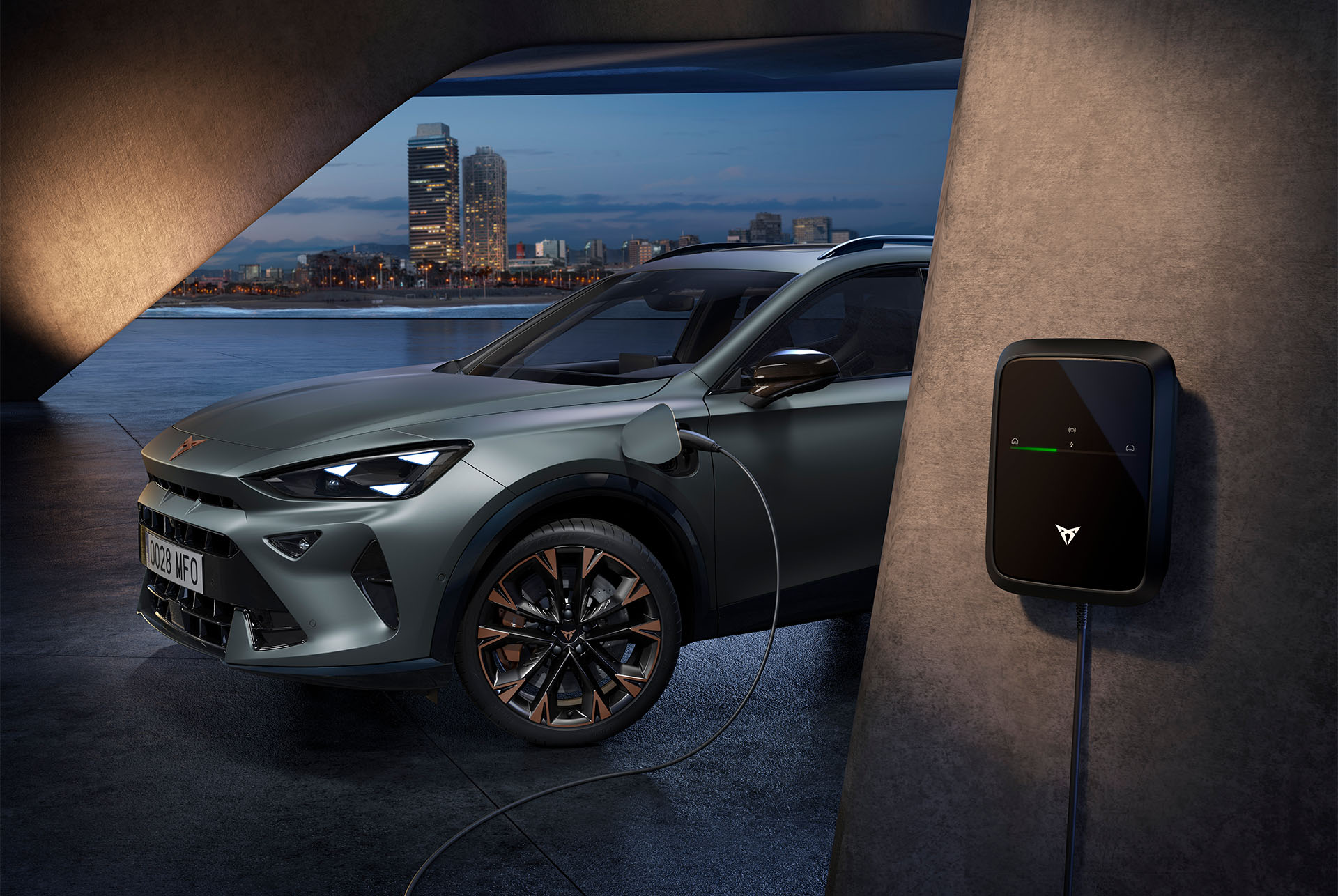 side view of the CUPRA Formentor in the colour Enceladus Grey matt, parked in an outdoors environment showcasing the car’s charging point.  