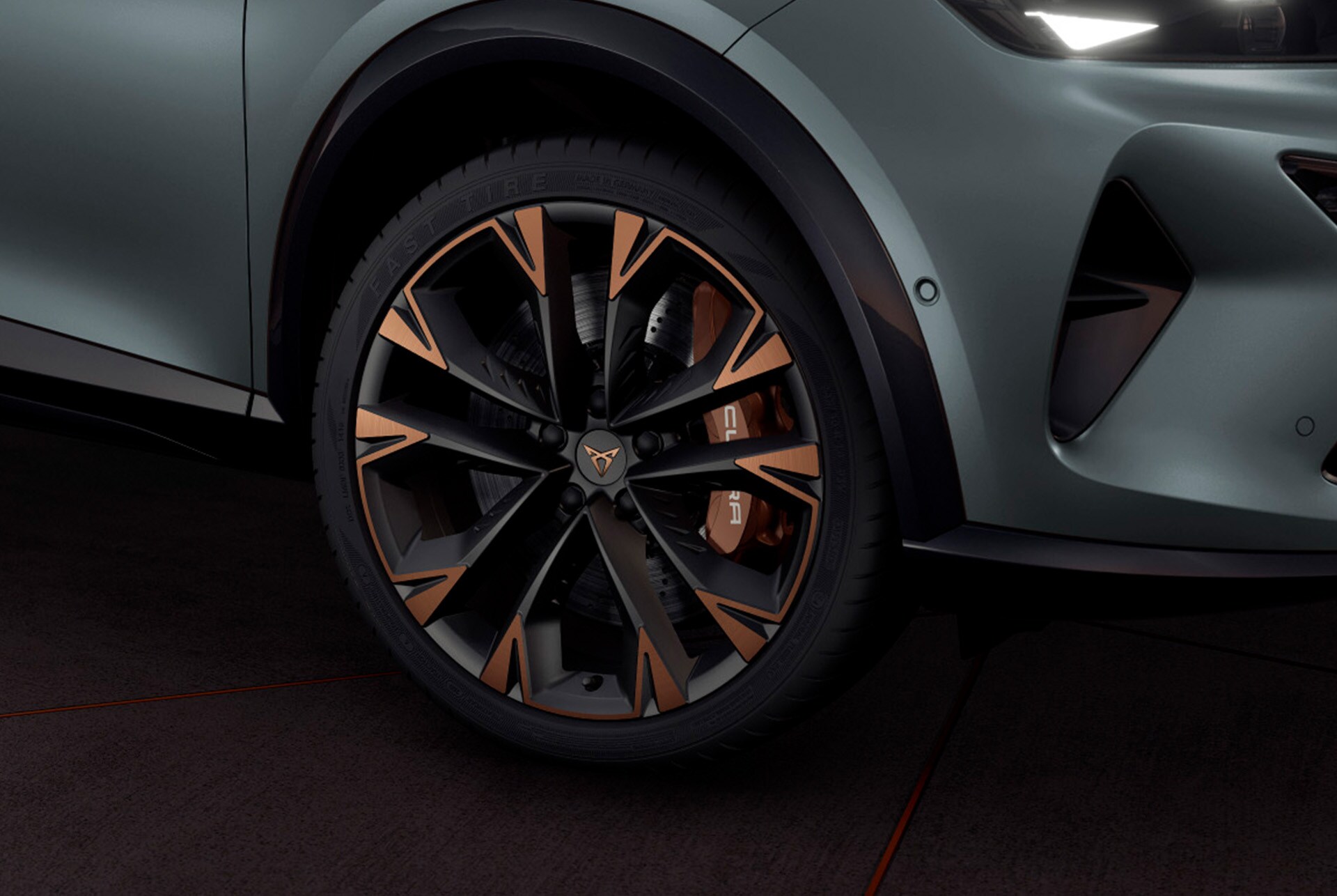 Exterior view of the CUPRA Formentor copper accent wheels, Akebono brakes, wing mirror, tyres, signature triangle eye LED headlights and CUPRA logo.