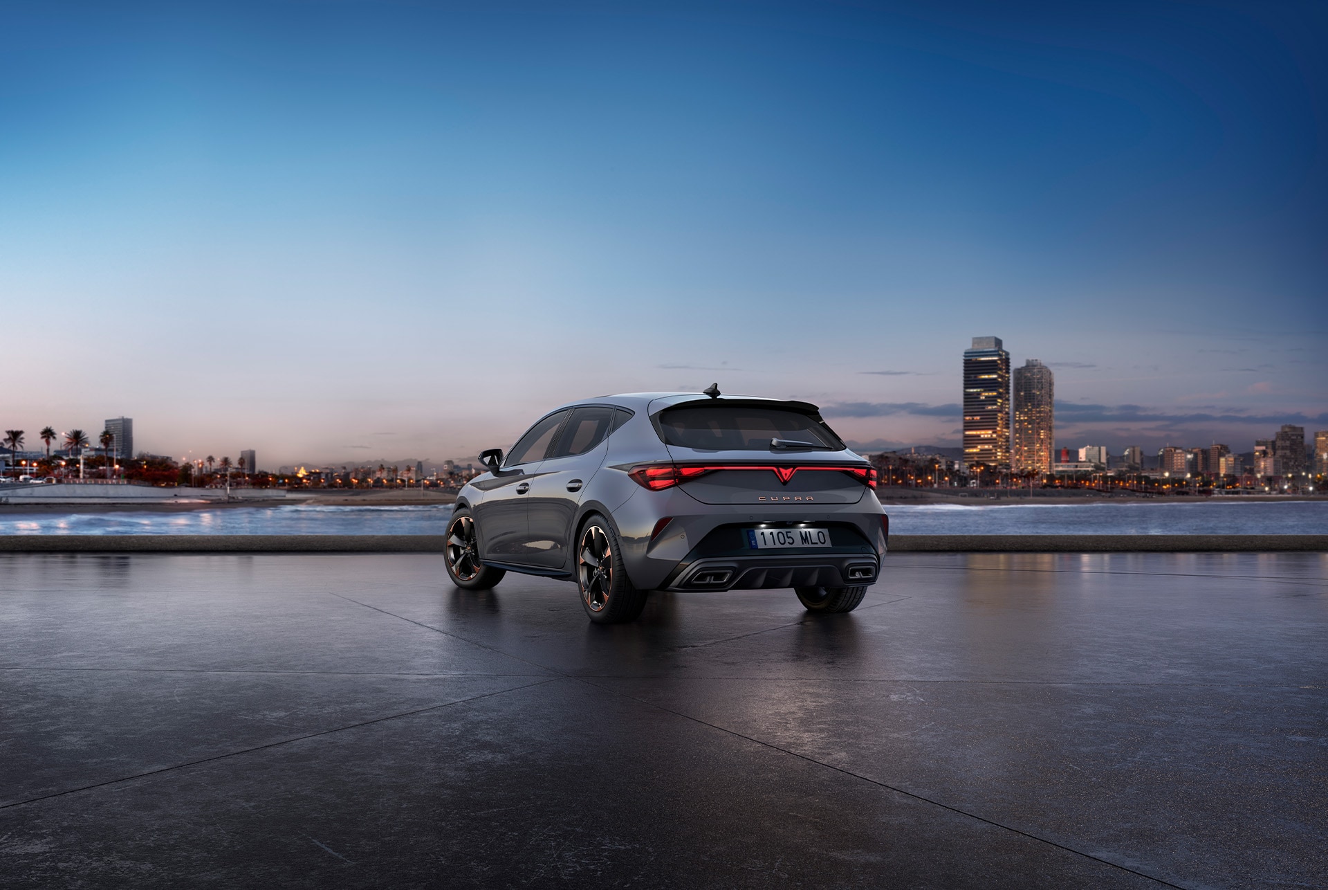Rear view shot of cupra leon glossy grey car model with dynamic chassis control, plus black and copper alloy wheels. City in the background at sunset.